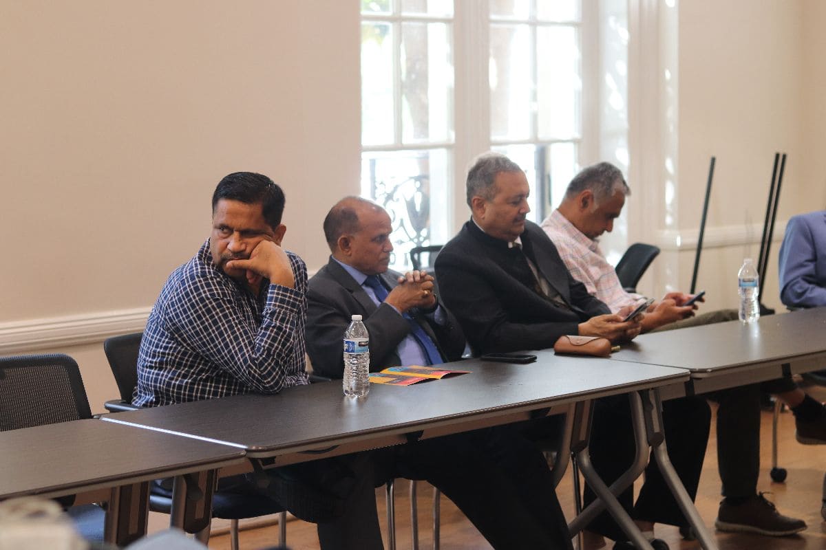 Delegates seated at discussion table